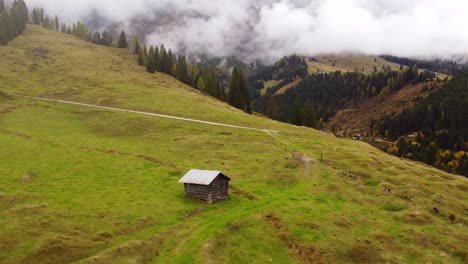 Tiny-picturesque-wooden-hut-in-Hochkonig-mountains,-Austrian-Alps,-rising-drone