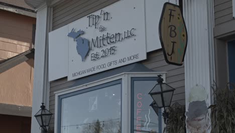 Tip'-N-Mitten-store-in-downtown-Grayling,-Michigan-with-video-tilting-down