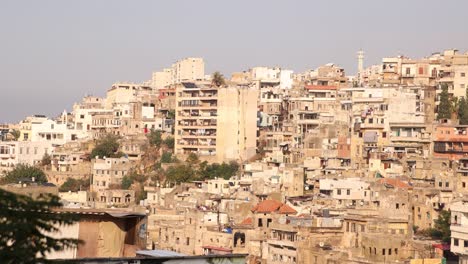panning-shot-with-view-of-rows-of-middle-eastern-apartment-buildings-on-the-hillside-of-Tripoli,-Northern-Lebanon
