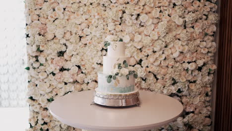 Elegant-Wedding-Cake-Against-Floral-Backdrop