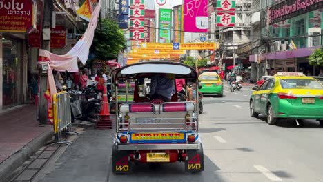 Tuk-Tuk-parked-at-the-roadside-waiting-for-customers-at-Yaowarat-Chinatown,-Bangkok,-Thailand