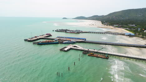 Drone-fly-above-Nathon-pier-in-koh-samui-fast-ferry-cruise-the-sea-reaching-travel-holiday-destination-famous-in-all-south-east-Asia