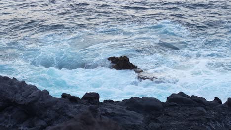 Waves-crashing-into-Tenerife-Los-Gigantes-volcanic-rocky-coast,-slow-motion