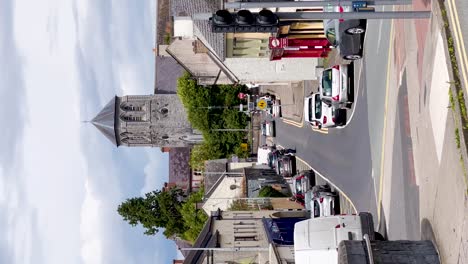 Sonniger-Tag-In-Kilcock:-Vertikales-Video-Des-Stadtlebens-Mit-Der-Katholischen-Kirche-St.-Coca,-Dem-Fußgängerüberweg-Und-Dem-Städtischen-Treiben-In-Der-Grafschaft-Kildare