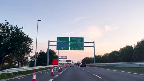 Evening-Commute:-Driving-on-The-N25-Motorway-Towards-Cork-City-with-Clear-Skies-and-Urban-Road-Maintenance-Signs