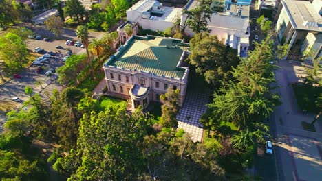 Cousiño-Palace-aerial-view-circling-green-rooftop-and-lush-ornate-heritage-site-gardens