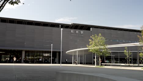 People-Walking-Towards-JR-Kumamoto-Railway-Station-Building-Front-Entrance-On-Sunny-Afternoon