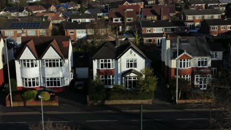Aerial-view-expensive-English-middle-class-houses-on-rural-suburban-neighbourhood-road