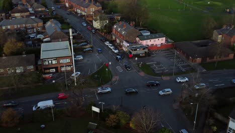 British-suburban-village-in-Merseyside,-England-aerial-view-over-cars-on-neighbourhood-streets