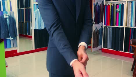 4K-Cinematic-fashion-clothing-footage-of-a-model-appreciating-his-new-suit-on-in-a-tailor's-shop