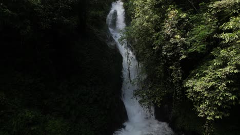 A-sunny-day-at-an-unknown-waterfall-in-the-depths-of-jungle-in-Bali,-Indonesia