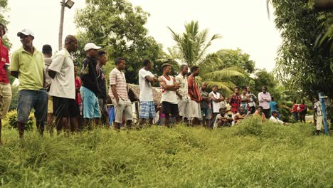 A-group-of-talking-people-on-the-street-during-a-"kabar"-meeting-in-a-village-in-the-nature-under-the-palm-trees