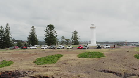 Aerial-drone-shot-tracking-left-closely-around-Kiama-lighthouse-on-a-stormy-day-in-south-coast-New-South-Wales,-Australia