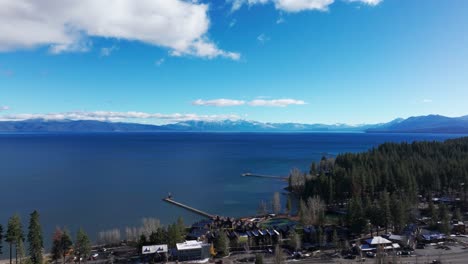 Panning-to-the-left-drone-aerial-shot-of-mountains-and-lake-tahoe