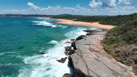 Dramatic-Aerials:-Spoon-Bay's-Rocky-Coastline-Meets-the-Serene-Wamberal-Beach,-Central-Coast,-NSW's-Nature-Reserve