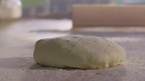 Dough-Dropping-onto-Flour-Covered-Kitchen-Surface