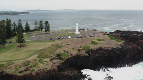 Aerial-drone-shot-tracking-left-around-Kiama-lighthouse-on-a-stormy-day-in-south-coast-New-South-Wales,-Australia