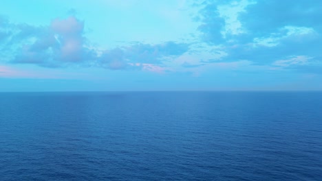 Cloudy-blue-sky-above-dark-blue-Caribbean-sea-ocean-water,-empty-blank-slate