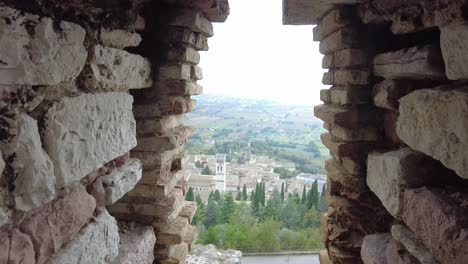 view-through-Rocca-Maggiore-castle-down-to-the-town-of-Assisi,-Italy