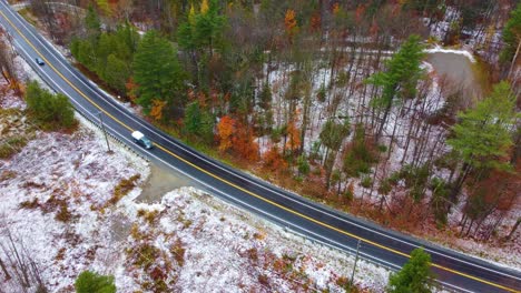 Descending-drone-shot-of-a-highway-on-the-side-of-Mount-Washington,-also-known-as-the-Home-of-the-World's-Worst-Weather-located-in-New-Hampshire,-United-States-of-America