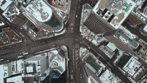 High-Altitude-Overhead-Vehicle-Traffic-4K-Time-lapse-Winter-Drone-Shot-Canadian-Roadway-Trans-Highway-One-Intersection-Portage-Avenue-and-Main-Street-Capital-City-Downtown-Winnipeg-Manitoba-Canada