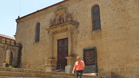 Old-Man-Talking-On-His-Phone-Walking-Outside-Misericordia-Church-In-Braga,-Portugal