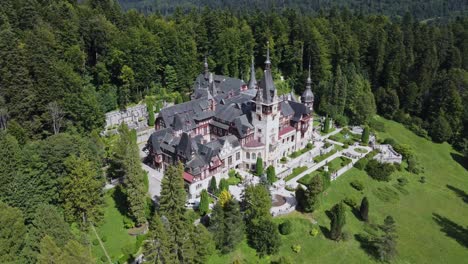 Aerial-Drone-circling-shot-around-Peles-Castle-in-Romania-in-nature