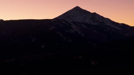 Drone-shot-panning-up-of-Lone-Mountain-in-Big-Sky,-Montana-at-sunset