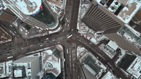 Rising-Establishing-Overhead-Vehicle-Traffic-4K-Time-lapse-Winter-Drone-Shot-Canadian-Roadway-Trans-Highway-One-Intersection-Portage-Avenue-Main-Street-Capital-City-Downtown-Winnipeg-Manitoba-Canada