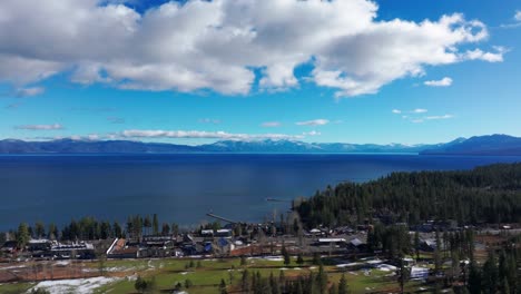 Pushing-in-drone-flyover-of-Lake-Tahoe-and-Tahoe-City-on-a-sunny-day