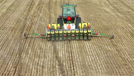 Tractor-with-planter-working-in-a-freshly-tilled-field