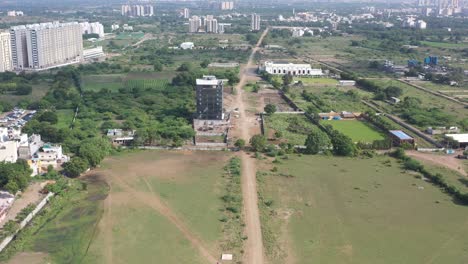 Rajkot-city-aerial-view-dawn-camera-high-rise-behind-which-there-are-many-tall-trees