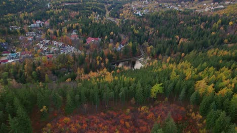 Karpacz,-Poland,-autumn-drone-tilt-down-view-of-a-mountain-city,-zapora-na-łomnicy