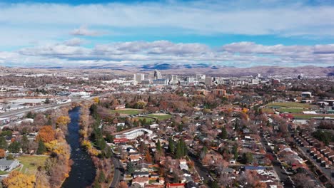Drone-view-panning-over-a-river-just-outside-of-downtown-Reno,-Nevada