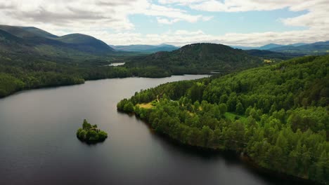 Aerial-Mystique-of-the-Highlands:-Loch-An-Eilein-and-Castle-Ruins-Surrounded-by-Scots-Pine,-Aviemore's-Natural-Heritage,-Cairngorms,-Scottish-Highlands,-Scotland,-UK