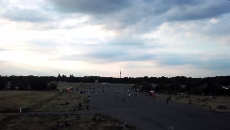City-of-Berlin-and-people-are-skating-at-decommissioned-Tempelhof-airport