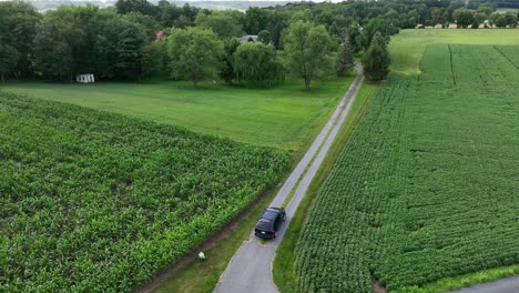Black-SUV-entering-farm-lane-in-rural-USA