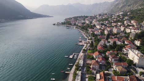 Drone-flyover-Kotor-Bay,-Scenic-village-by-the-Adriatic-sea,-Montenegro