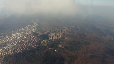Drone-strafing-to-the-left-showing-the-Belogradchik-town-and-the-natural-rock-formations-of-the-Belogradchik-Fortress,-in-the-province-of-Vidin-in-Bulgaria