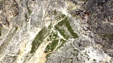 Climbers-resting-on-mountain-ridge,-ferrata-in-Dolomites,-Italy
