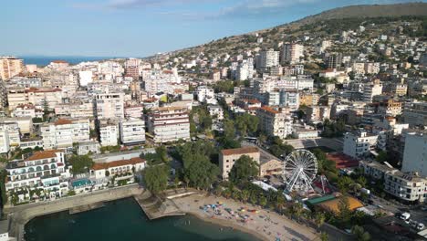 Drone-Flies-Over-Saranda-Beach-and-City-on-Summer-Day-in-Albanian-Riviera
