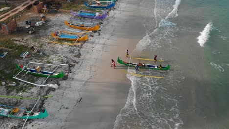 Green-fishing-boat-arrived-on-Serdang-beach-at-belitung-Indonesia,-aerial