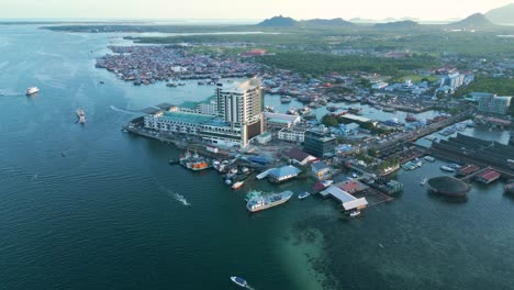 panoramic-aerial-view-of-Semporna,-touristic-seacoast-village-panoramic-aerial-overview-during-sunset