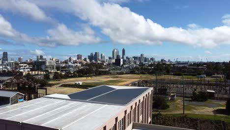 Descending-from-skyline-view-of-Perth-down-from-rooftop-of-abandoned,-disused,-derelict-Art-Deco-Power-Station-Warehouse-Factory-in-East-Perth
