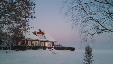 Cozy-family-home-in-winter-season-in-Scandinavia,-sunset