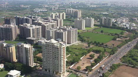 RAJKOT-CITY-AERIAL-VIEW-drone-drone-camera-showing-Lorais-building-and-party-plot-amidst-lots-of-fields-and-dense-trees