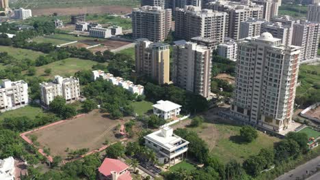 RAJKOT-CITY-AERIAL-VIEW-Drone-camera-moving-downwards,-with-bungalows-and-plains-visible-in-front