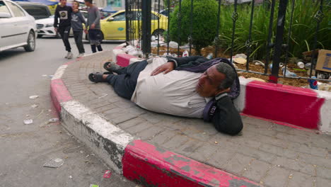 Beggarman---Homeless-Man-Lying-On-The-Street-In-Hebron,-Palestine