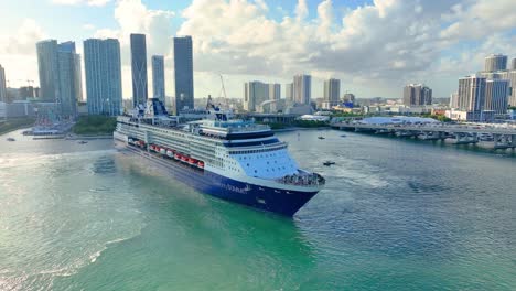 Gorgeous-aerial-view-of-beautiful-white-and-blue-cruise-ship-docking-at-Miami-harbour