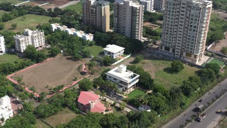 RAJKOT-CITY-AERIAL-VIEW-Many-bungalows-complex,-garden-and-drone-landing-near-Kalavad